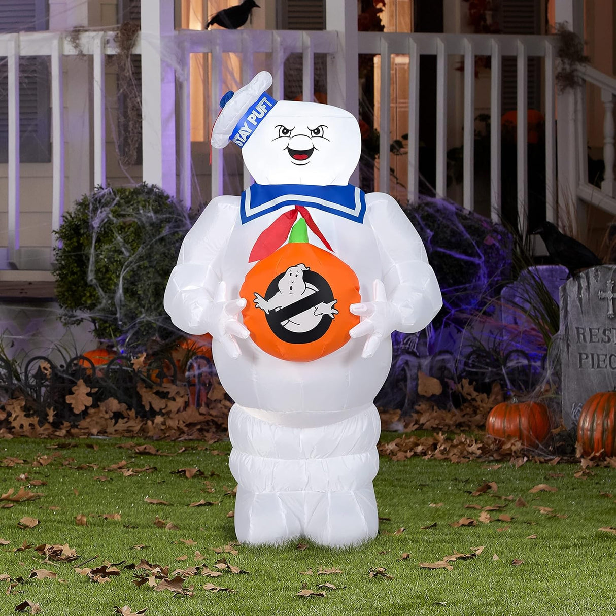 This shows the Stay Puft Marshmallow Inflatable in front a house decorated for Halloween.
