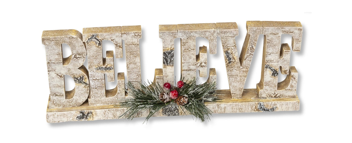 Tabletop decoration that looks like it was carved out of birch wood. This one reads "BELIEVE" and features pine cone, pine needle and berry accents.