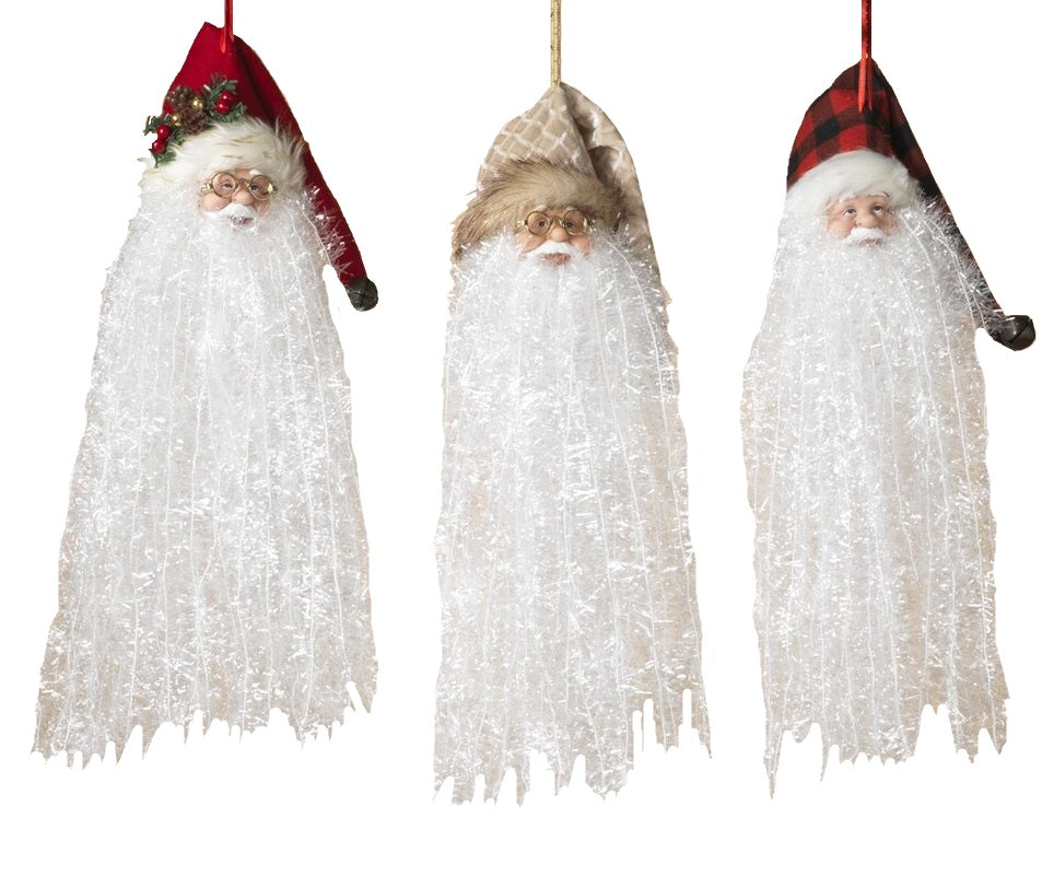 Santa with long white beard ornament. Available in 3 different styles. One Santa is wearing a red stocking cap featuring pine needles, faux berries and a pine cone. One Santa is wearing a red and black buffalo plaid stocking cap. One Santa is wearing a white and gold stocking cap.