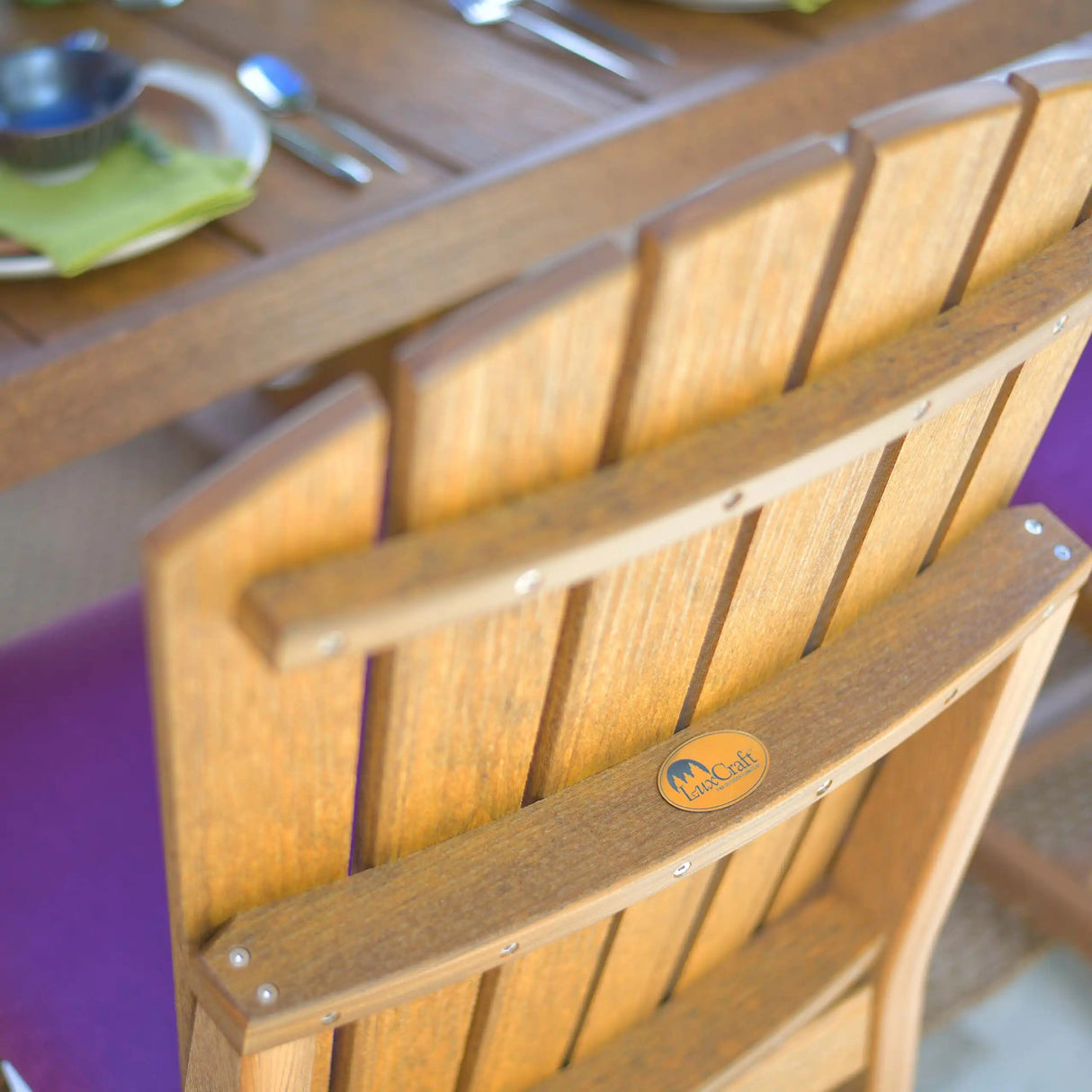 This is a lifestyle image showing the back of the Antique Mahogany Adirondack Arm Chair.