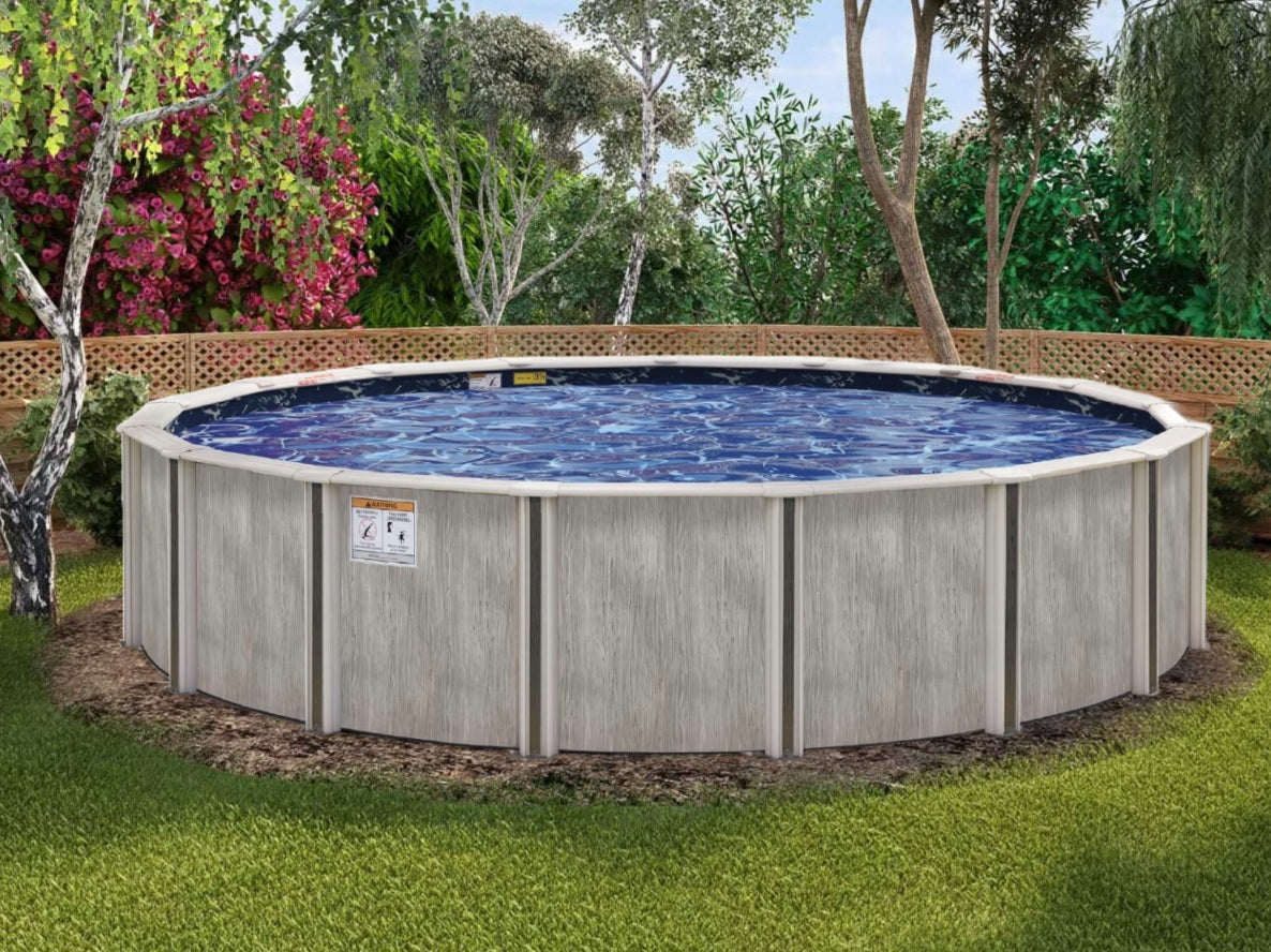 A semi-inground pool in a grassy backyard next to a wooden fence.