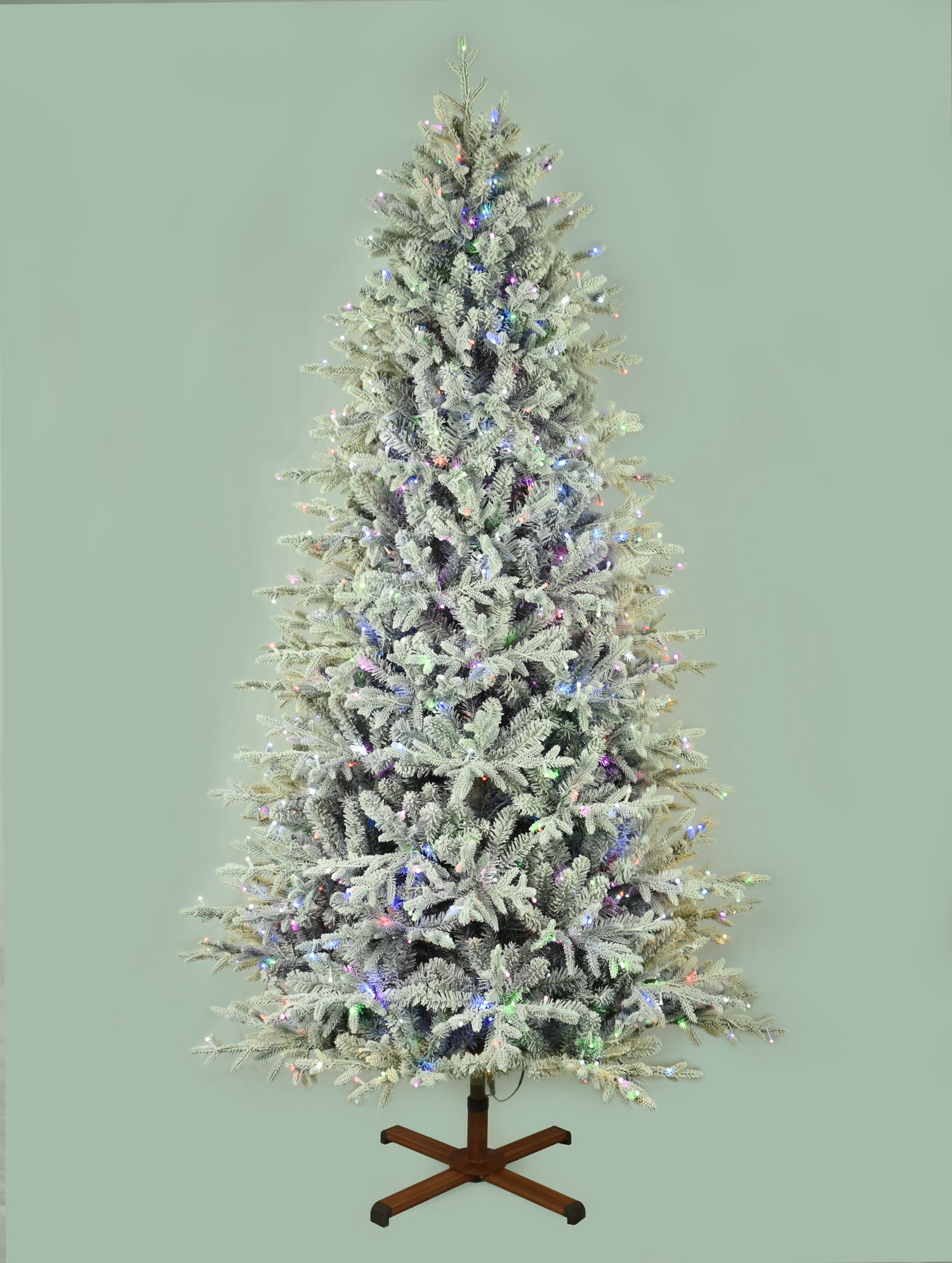 This image shows the flocked Christmas tree pre-lit with Multi-Colored Starry Lights. The tree is up against a light gray background.