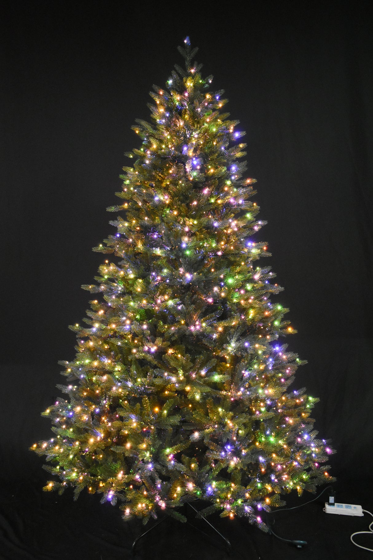 Artificial tree pre-lit with multi-colored starry LED lights.