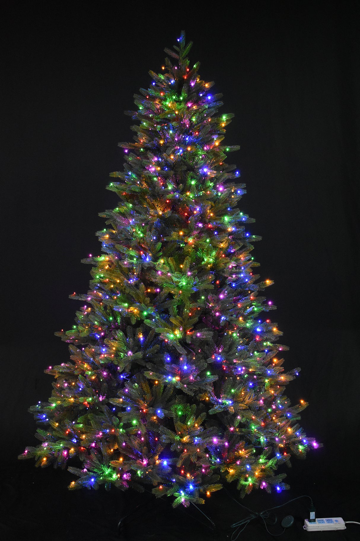 Artificial tree pre-lit with multi-colored, starry LED lights.