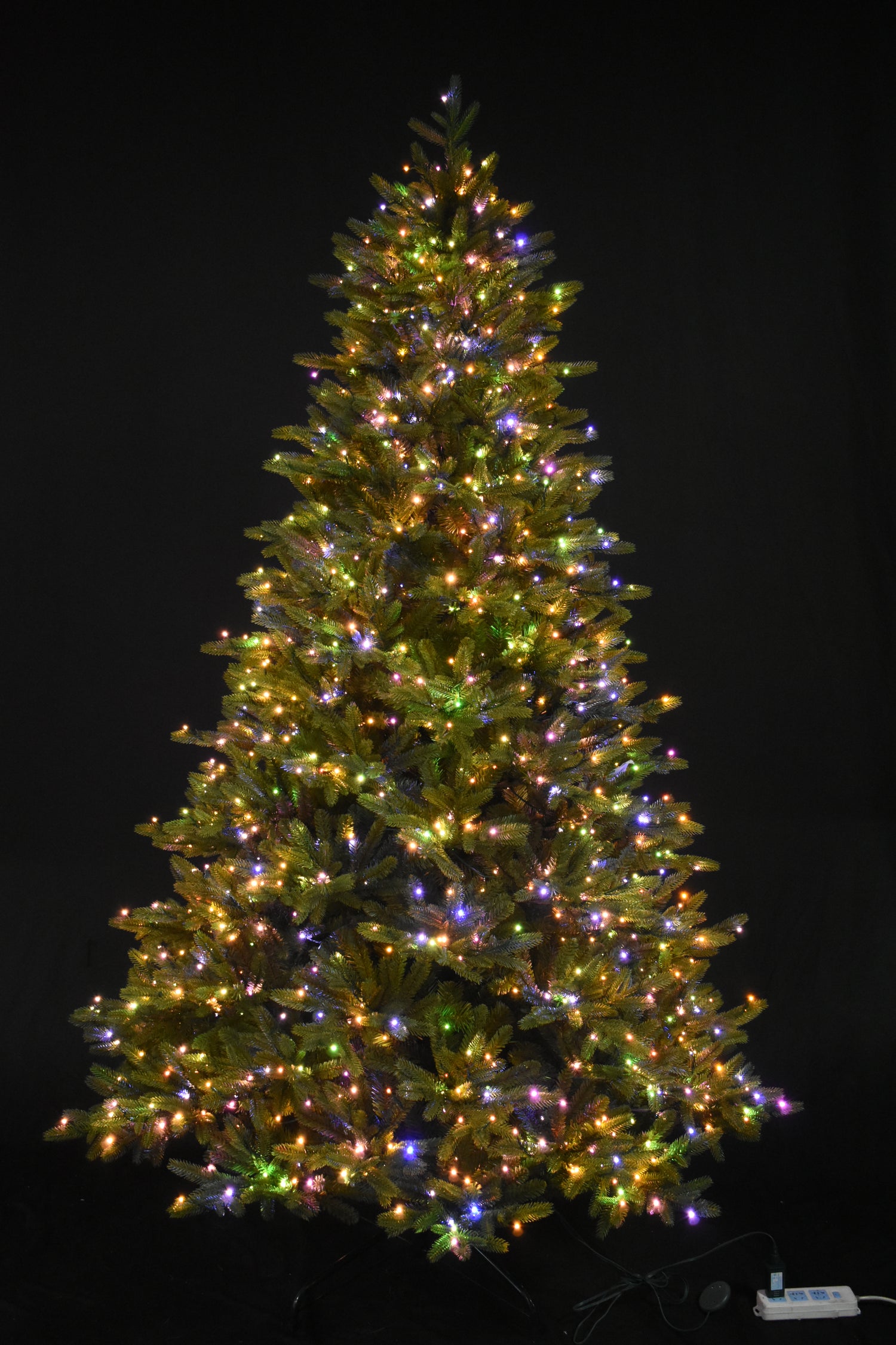 Artificial tree pre-lit with multi-colored, starry LED lights.