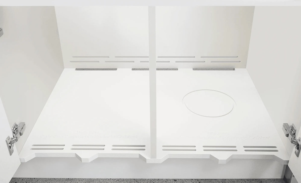 The inside of one of the outdoor kitchen cabinets.