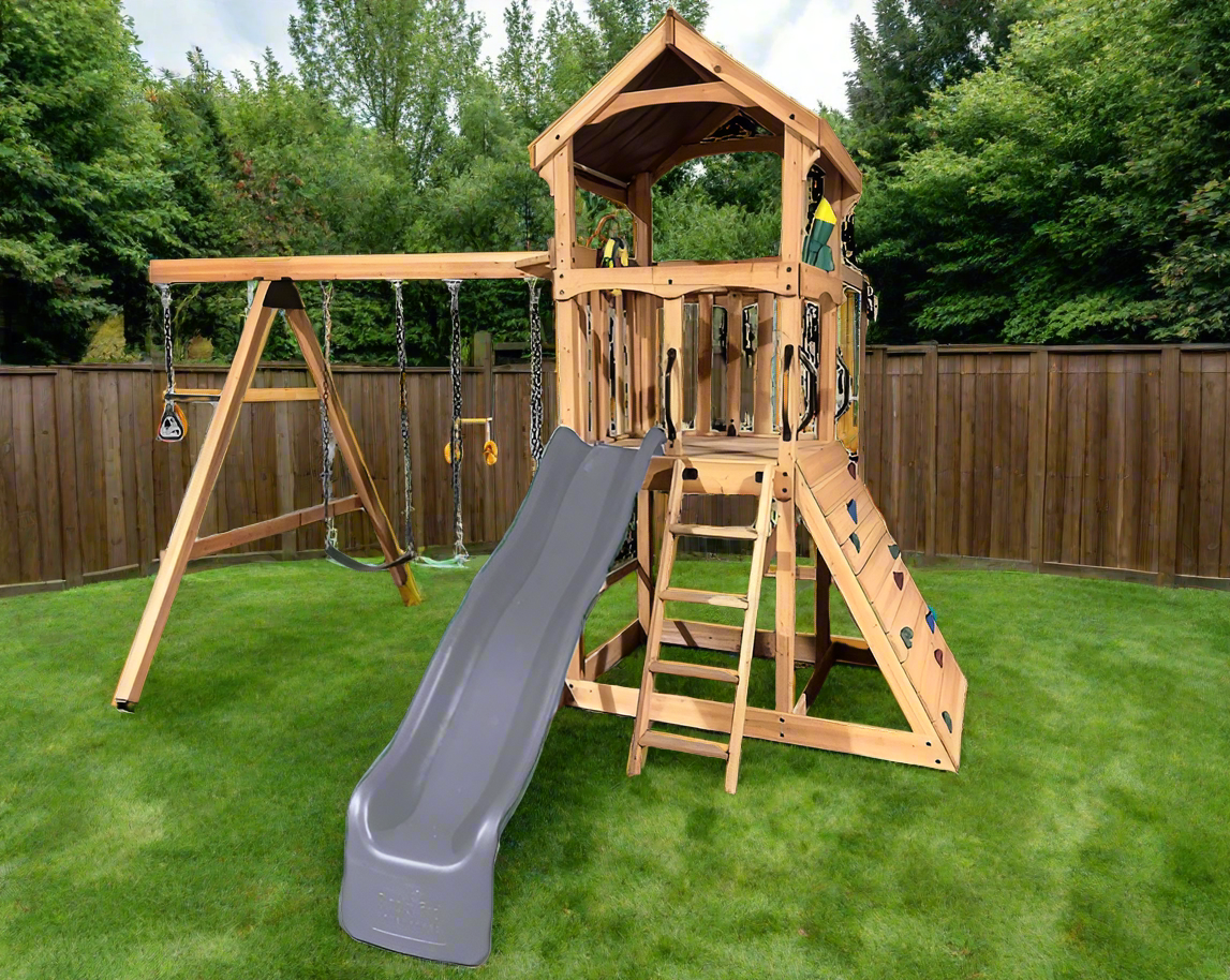 Wooden backyard playset in a sunny backyard. It features a 9‘ Double Wall Wave Slide, a durable Wooden Roof, a Rockwall, a Trapeze Bar with Rings, 2 Belt Swings, a 2-Position Swing Beam and a Wooden Entry Ladder with Handles.