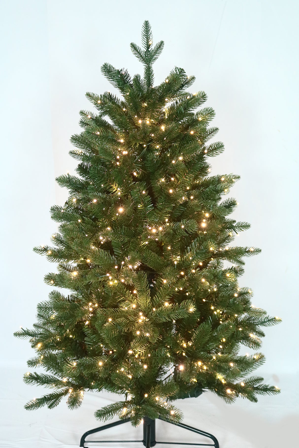 Artificial Christmas tree pre-lit with color-changing LED lights.