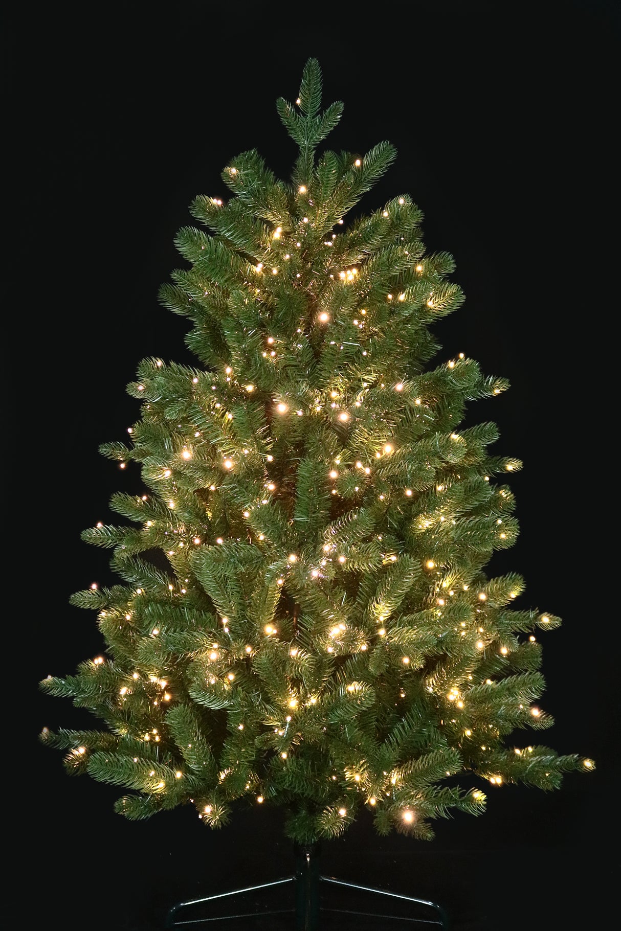 Artificial Christmas tree pre-lit with color-changing LED lights.