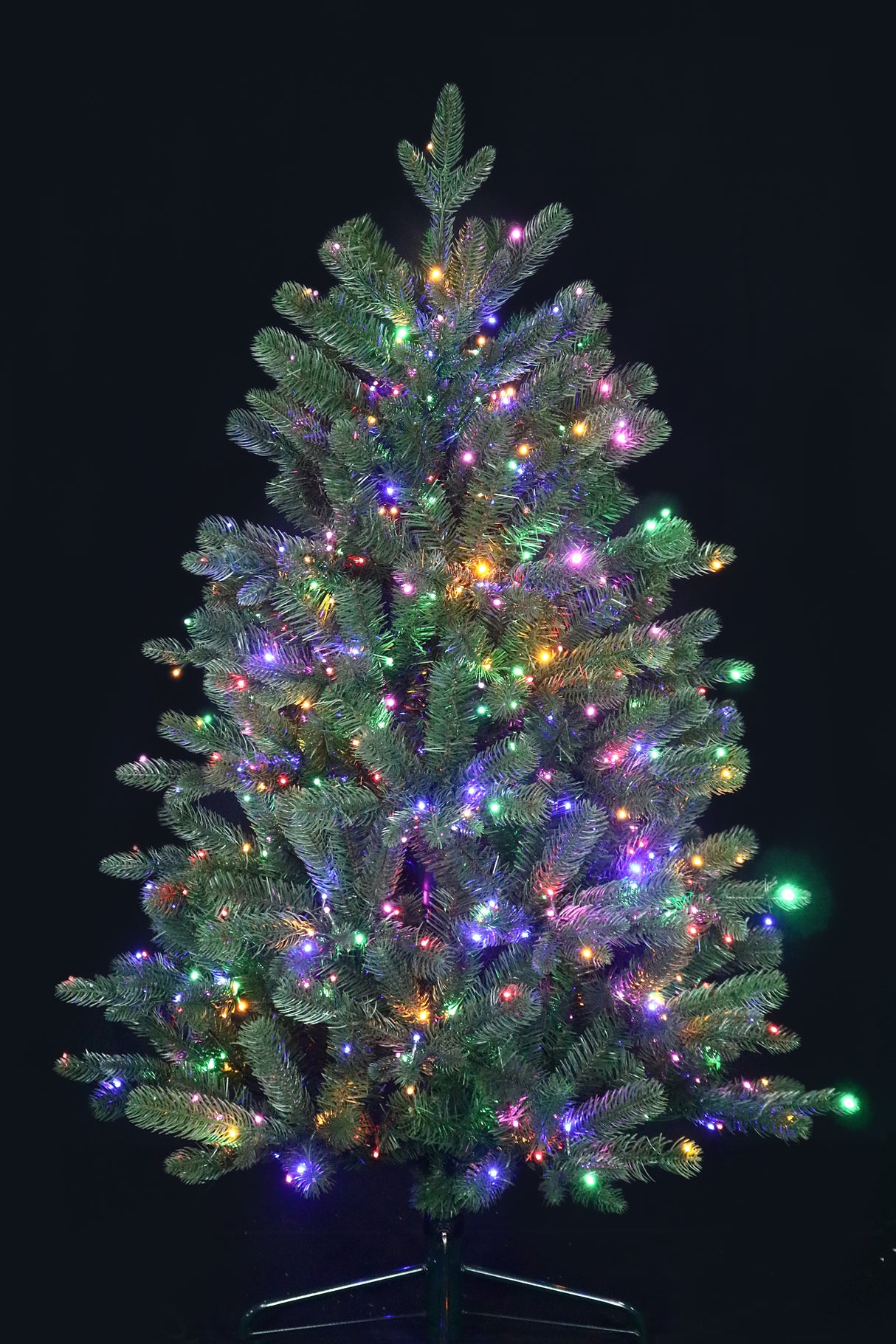 Artificial Christmas tree pre-lit with color-changing LED lights.