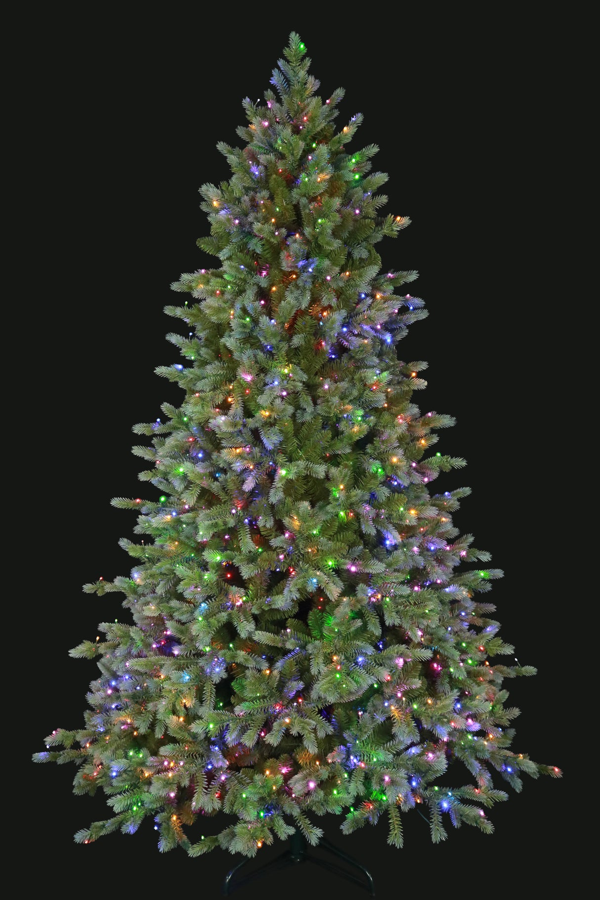 This is an image showing this artificial tree pre-lit with Multi-Colored Starry Lights. This tree is up against a black background.