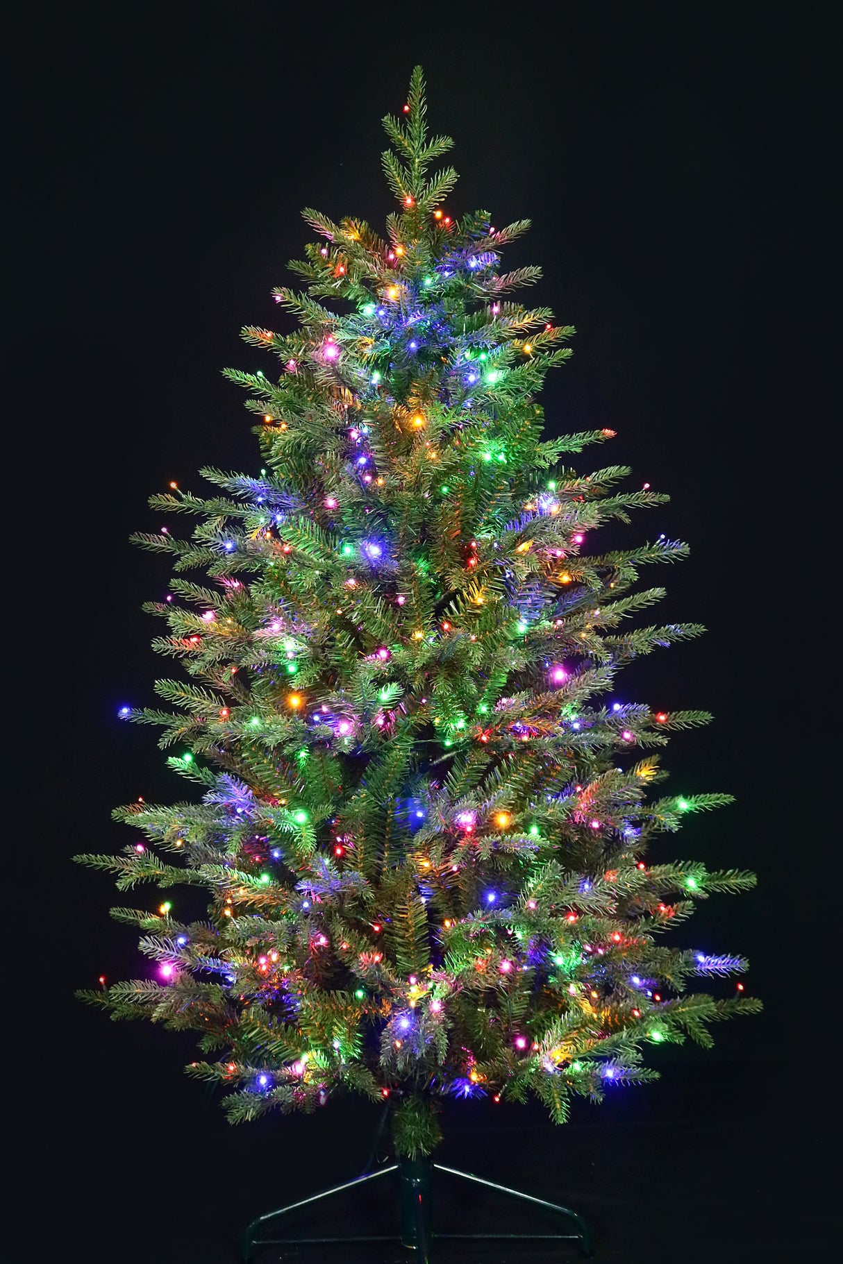 Artificial Christmas tree pre-lit with color-changing LED lights.