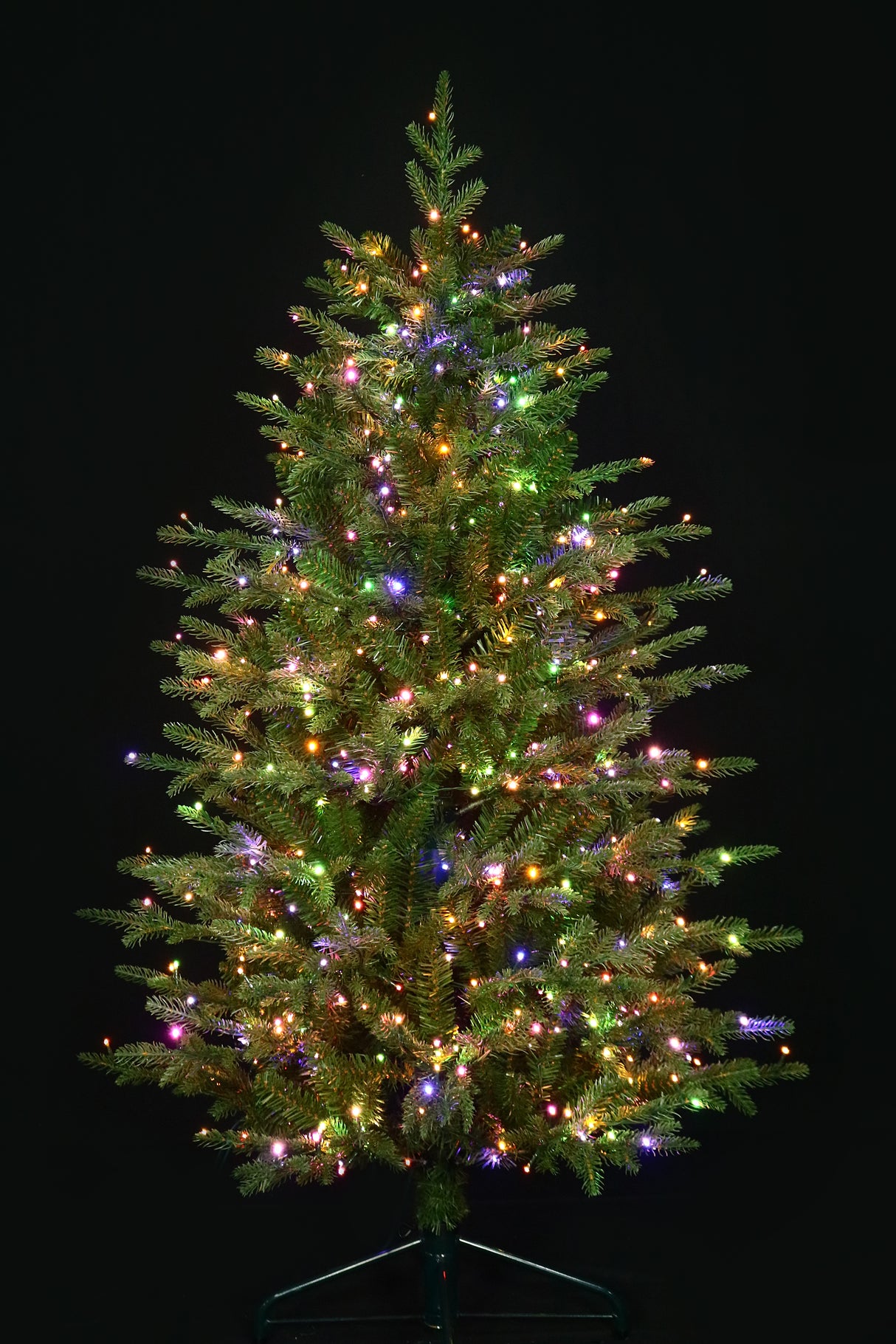 Artificial Christmas tree pre-lit with color-changing LED lights.
