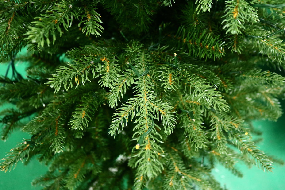 Artificial Christmas tree pre-lit with color-changing LED lights.