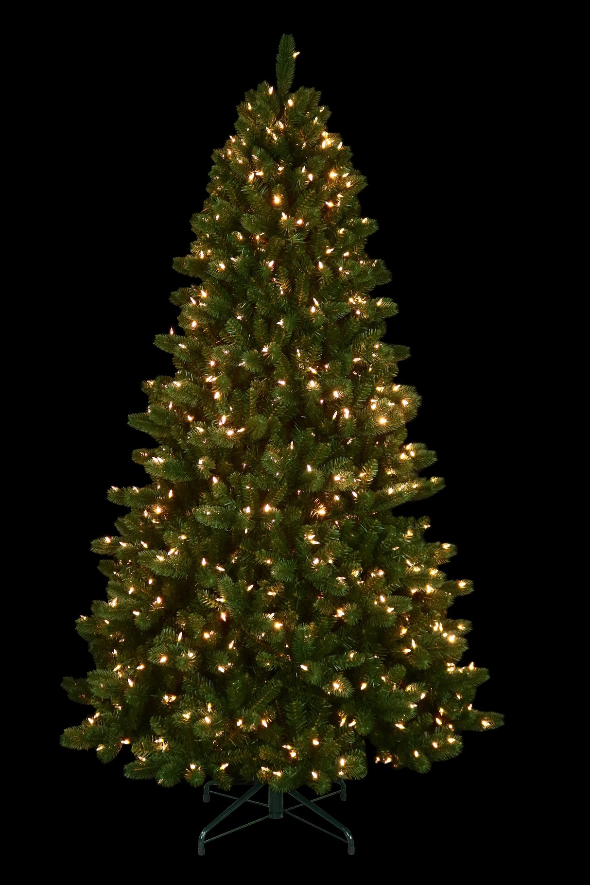 This is an artificial tree with the Warm White Starry Lights on. This tree is up against a black background.