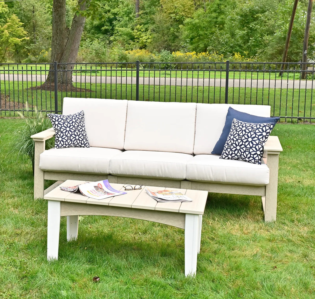 This is a lifestyle image showing a three person sofa with Birch frames and Canvas colored cushions.