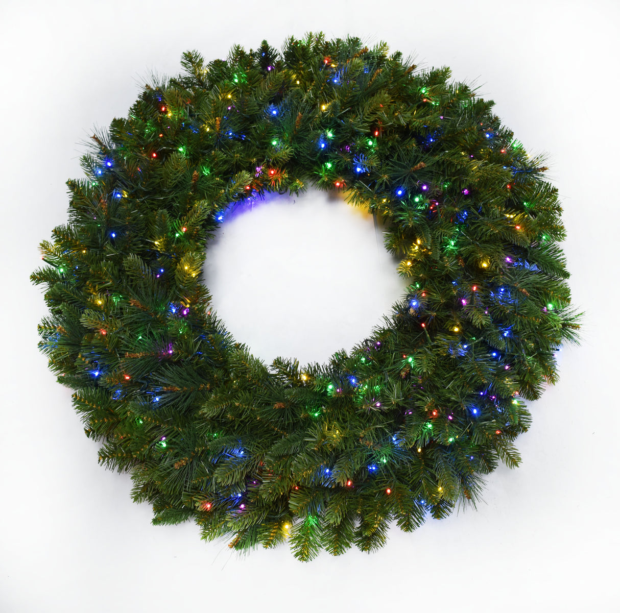 This image shows an artificial pine wreath on a white background pre-lit with multi-colored lights.