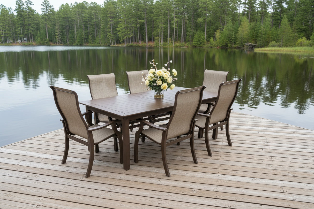 This image shows this patio dining set on a wooden dock next to a lake.