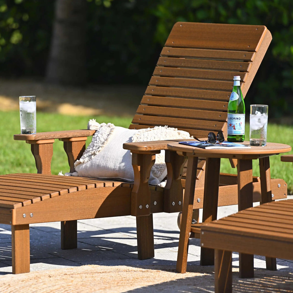 This is a lifestyle image showing an Antique Mahogany colored lounge chair next to a matching table.