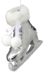 Silver ornament shaped like an ice skate. The cuff of the skate and the skate itself are furry and there are two pom poms tied to it.
