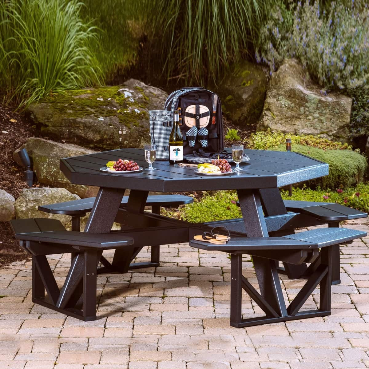 This is a lifestyle image showing the Black colored picnic table with benches attached.