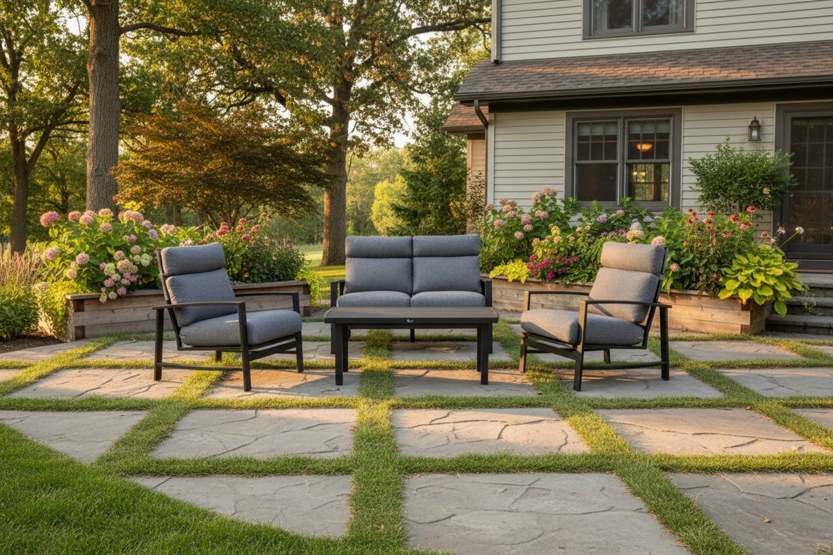 This is a lifestyle image showing this patio furniture set on a stone patio in a grassy backyard.