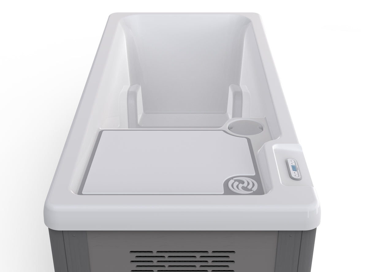 Long, rectangular tub designed for a cold plunge. The cabinet color is a tan-ish gray color and the inside is white. There's one seat.