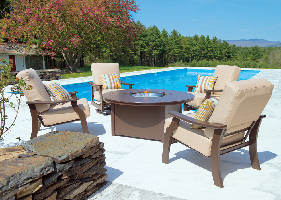 This is a lifestyle image showing this patio furniture set on a concrete patio next to an in-ground pool.