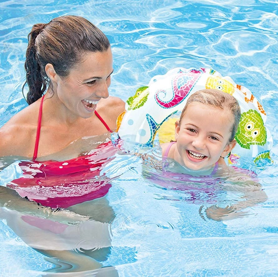 Inflatable inner tube with different colored cartoon fish on it. The fish have a mosaic design.