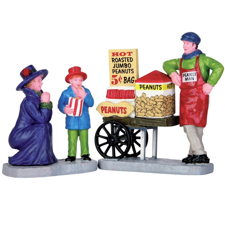 Village accent for a Lemax display. Designed to look like a peanut vendor leaning up against his cart. There's a mom excitedly watching her son eat peanuts.
