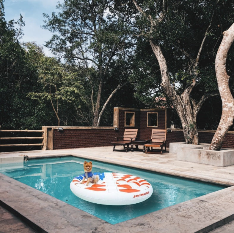 A pool float designed to look like a peace sign made out of the American flag.