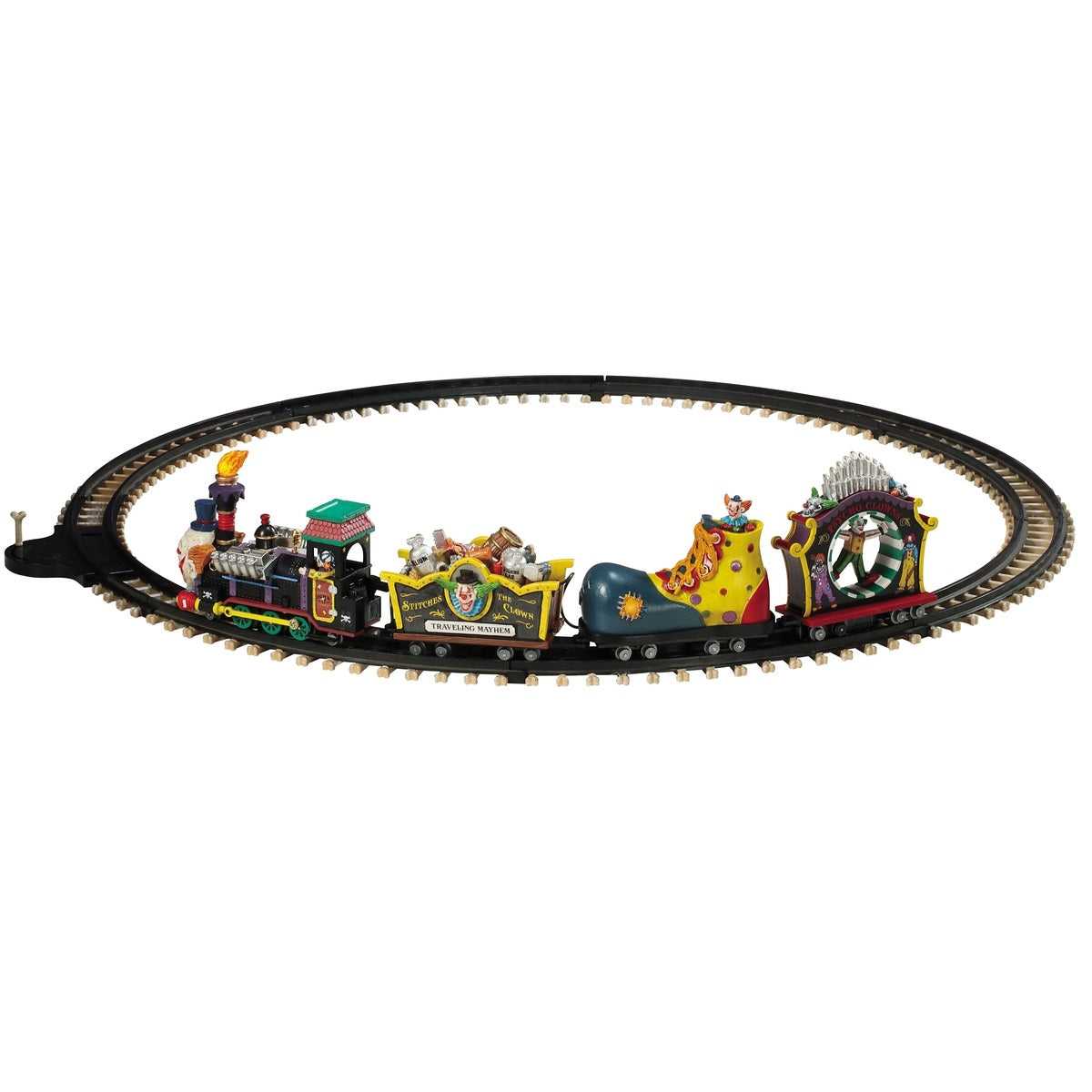 Polyresin train on a set of tracks for a Lemax display. The train cars are all different. The head of the train is the face of a clown. The second one is full of silver and wooden barrels and the side reads "Stitches the Clown: Traveling Mayhem." The third car is shaped like a giant clown shoe. The last one is shaped like a carnival ride where it spins you in a circle.