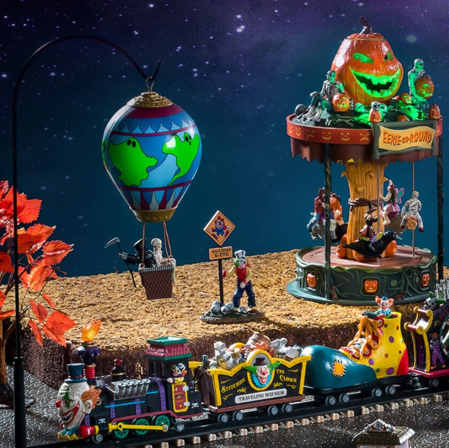 Lemax display that looks like a carnival. There's a train, a hot air balloon and a merry-go-round.