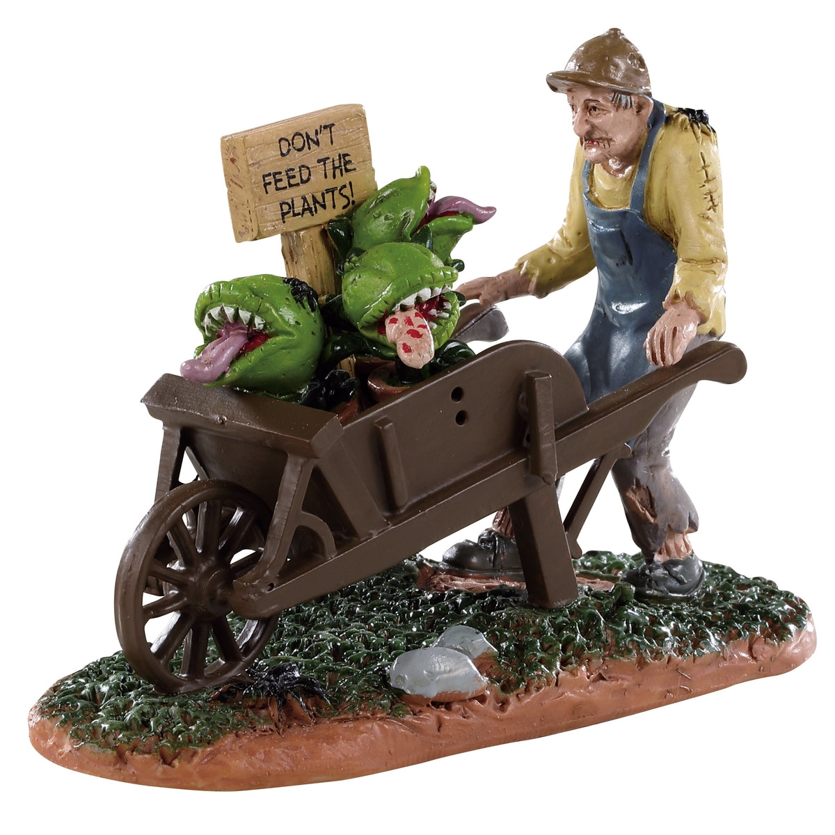 Polyresin figurine for a Lemax display. Designed to look like a man wearing overalls pushing a wheelbarrow full of Venus fly traps. There's a sign that reads "DON'T FEED THE PLANTS!"