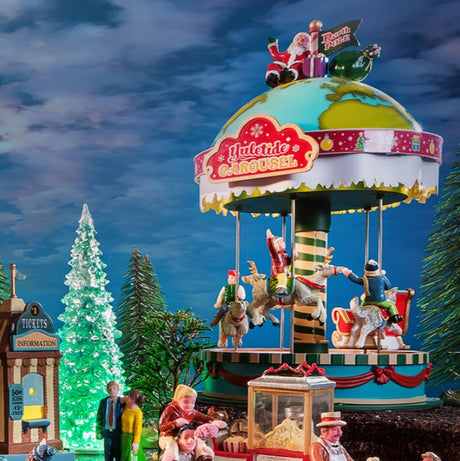 Lemax display consisting of the Yuletide Carousel, trees and people