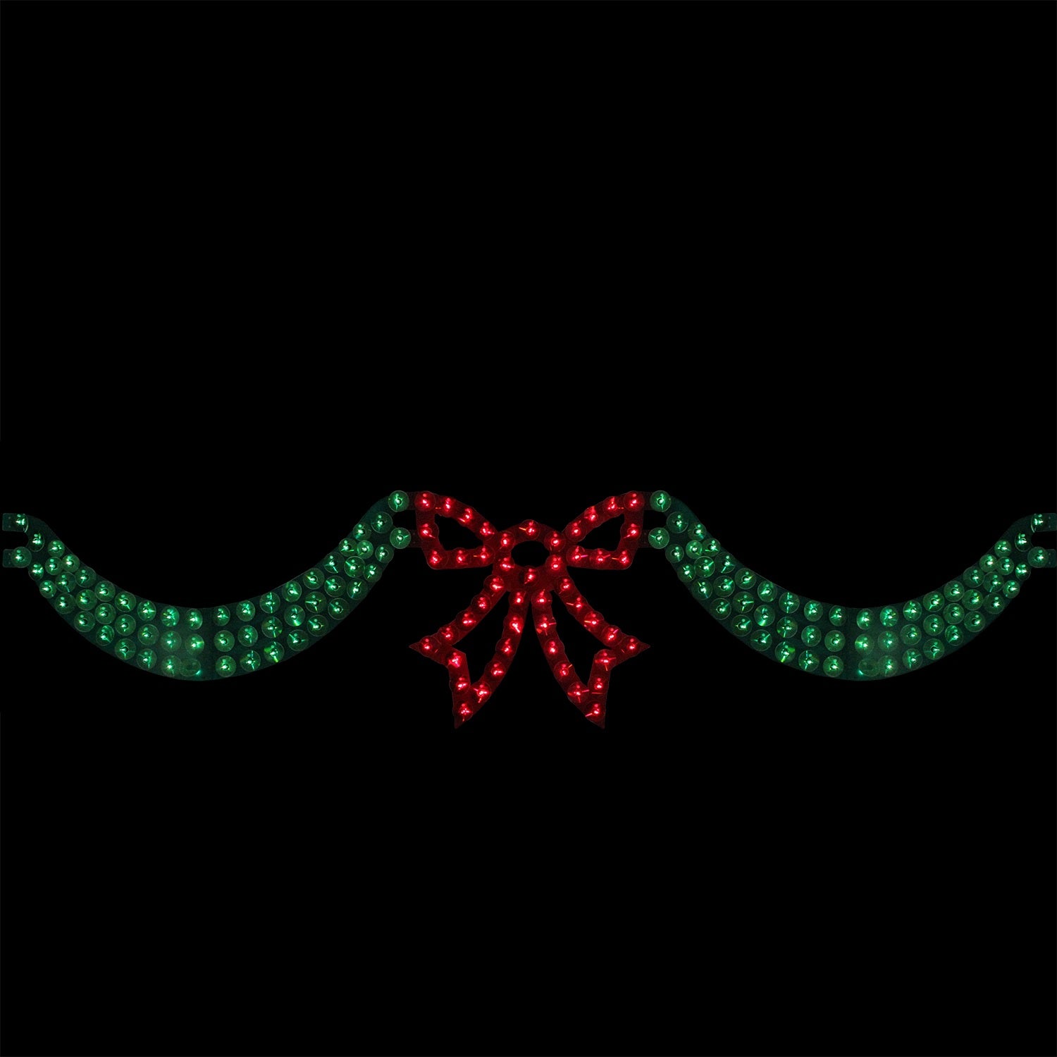 6 foot long lighted Christmas decoration designed to look like green ribbon with a red bow in the center. The background is black so you can see what it would look like at night.
