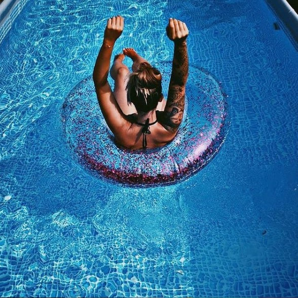 Clear inflatable inner tube with glitter inside. This tube has purple glitter.