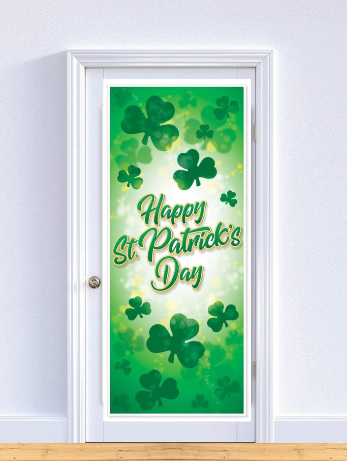 Decoration you hang on a door. The door cover is different shades of green with different sized shamrocks. There are specks of yellow. In green and yellow cursive it reads "HAPPY ST. PATRICK'S DAY!"