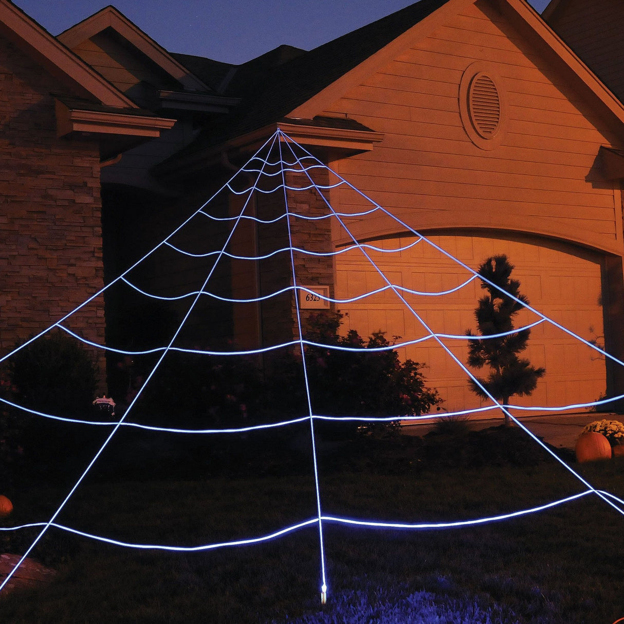 Massive spider web yard decoration for Halloween. It lights up under black lights.