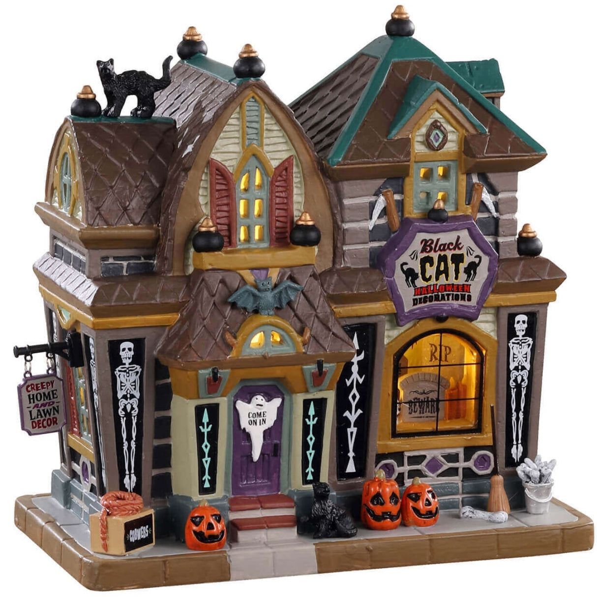 Porcelain lighted building for a Lemax display. Designed to look like a large shop. There's a black cat on the roof and carved pumpkins near the front door. There are skeleton accents and a bat near the front door.