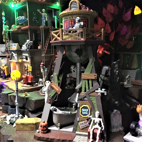 Polyresin village accent for a Lemax display. Designed to look like an old timey Western water tower. There are skeletons and pumpkins and a ghost.