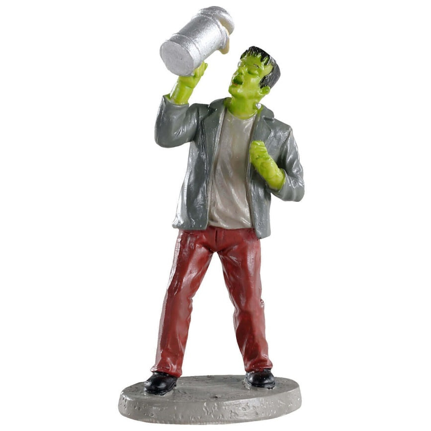 Polyresin figurine for a Lemax Spooky Town village display. Designed to look like Frankenstein chugging beer from a mug. He's wearing a gray suit jacket, a tan-ish shirt and red pants.