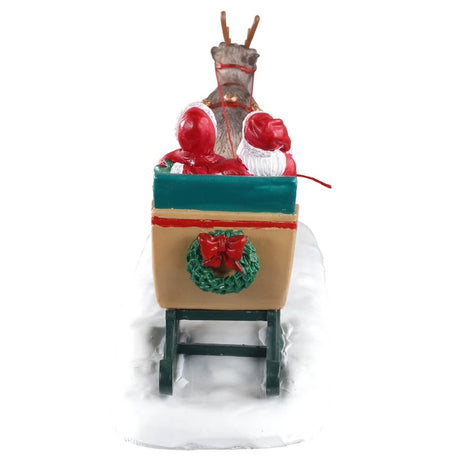 Polyresin figurine for a Lemax Village tabletop display. The back of the sleigh features a wreath with a red bow. You see the backs of Santa's and Mrs. Claus's heads