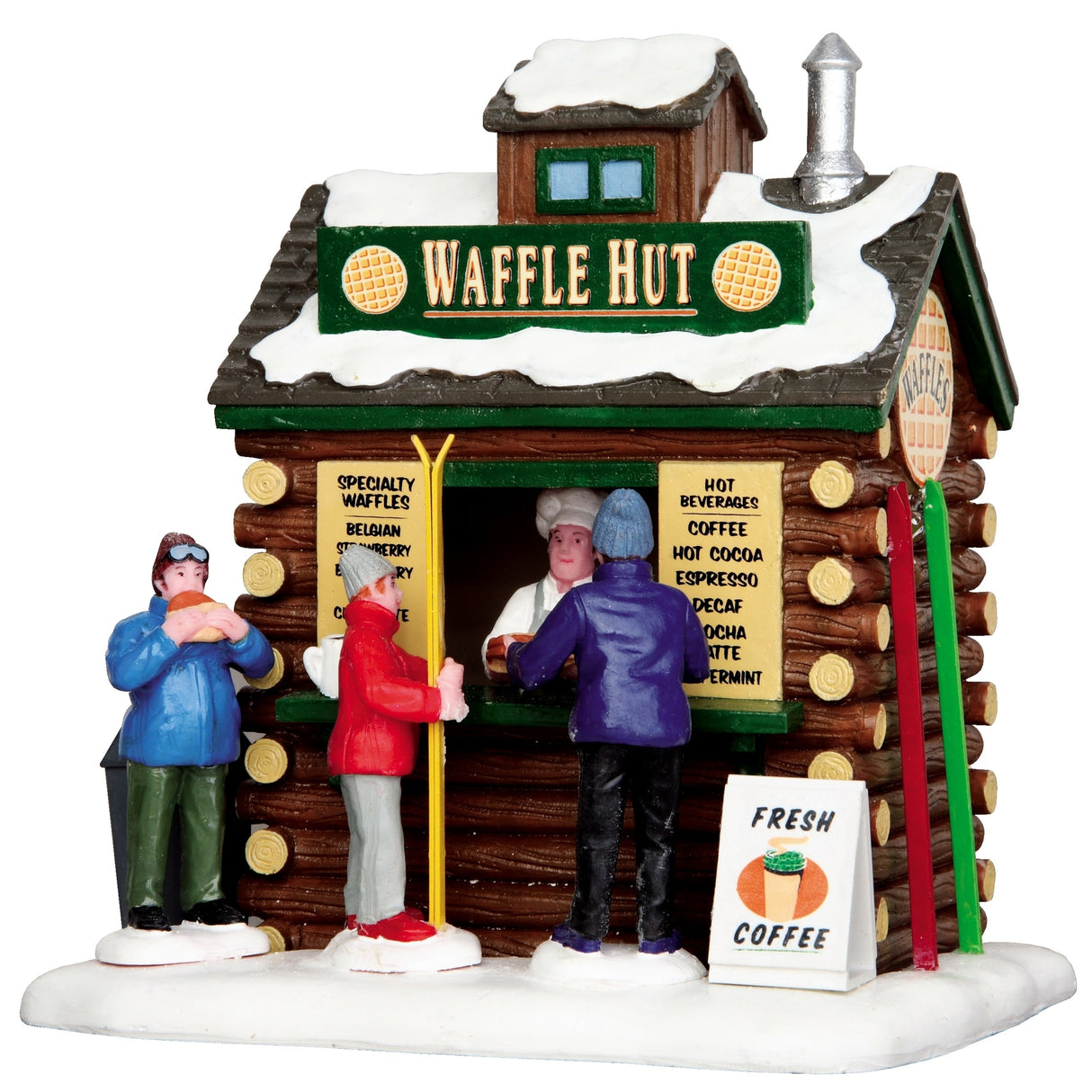 Polyresin building for a Lemax display. Designed to look like a small log cabin covered in snow. The sign on the roof reads "Waffle Hut" and features two waffles. There are three people in line. There are skis leaning up again the side of the cabin. There's a sign on the ground that reads "Fresh Coffee."