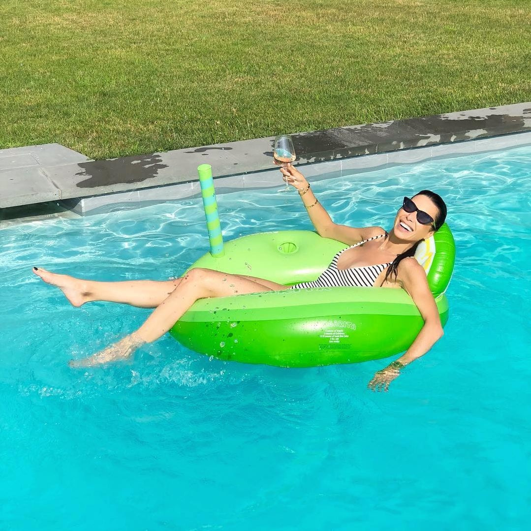 Green inflatable inner tube that reads "margarita." It's designed to look like it has a straw coming out of it and a back rest shaped like a lime.