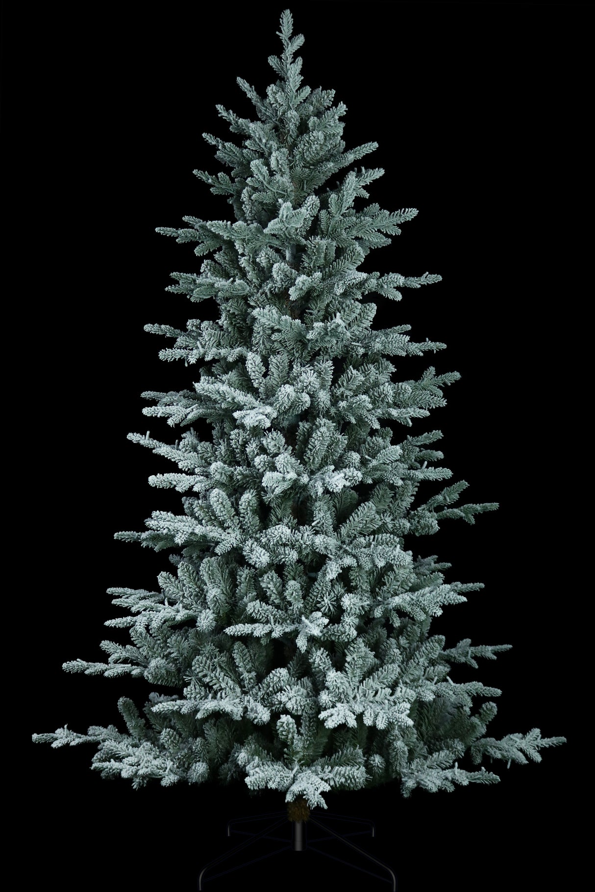 Artificial tree pre-lit with Starry lights. Branches are covered in white to appear covered in snow.