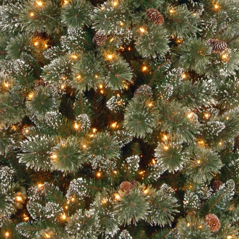 Artificial tree with white glitter on the branches. Pre-lit with clear lights.