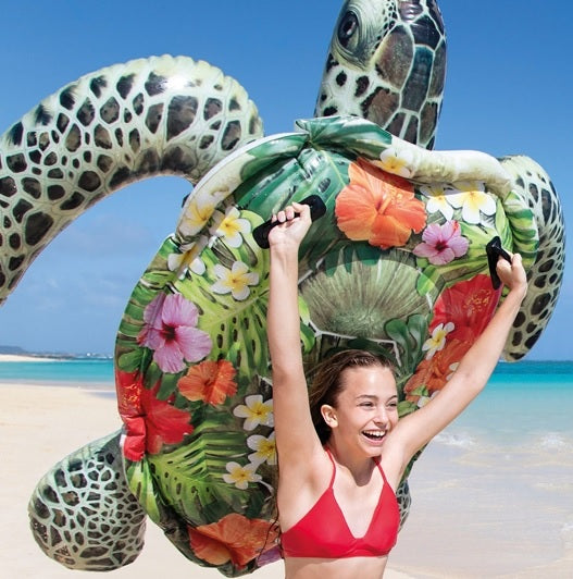 Inflatable pool float shaped like a turtle. This one's shell has tropical flowers on it.