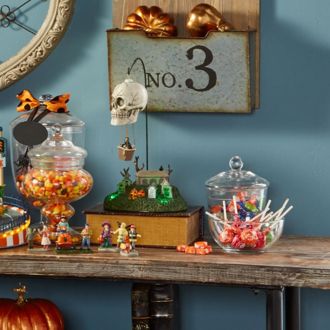 Porcelain accent for a Lemax display. Designed to look like a hot air balloon shaped like a skull flying above a cemetery.