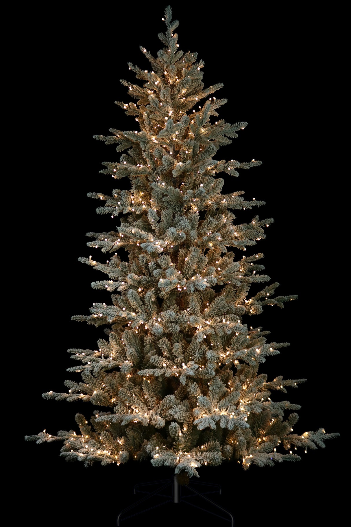 Artificial tree pre-lit with Starry lights. Branches are covered in white to appear covered in snow.